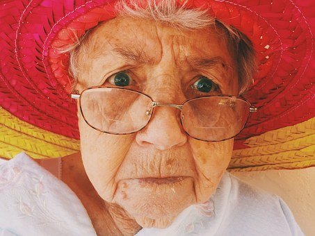 Grandma Gertie wearing glasses and her red hat