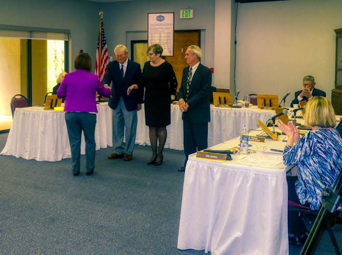 CEO of Hot Springs Village POA, Lesley Nalley gives oath of office to Dick Garrison, Diana Podawiltz and Tormey Campagna