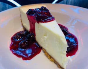 New York Style Cheesecake Topped With Alanna's Warm Brandy Blueberry Compote at Tanner's Neighborhood Bar & Grill
